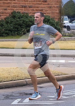 46 year-old Caucasian man running a 5K Turkey Trot Race on Thanksgiving in Edmond, Oklahoma.