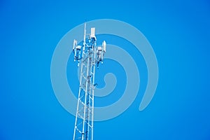 4G or 5G mobile station antenna cell site against on blue sky