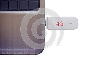 4G modem connected in modern notebook closeup isolated on white background.