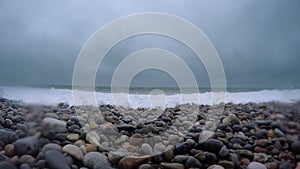 4K 3840x2160 video: pebble coastline with storm waves and clouds