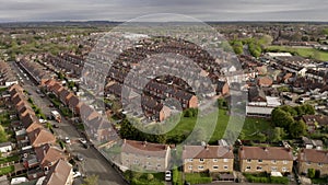 4K aerial above rows of back to back terraced houses on a council estate