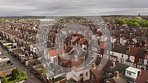 4K aerial above rows of terraced housing on a council estate