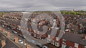 4K aerial above rows of terraced housing on a council estate