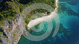 4K Aerial circle fly over tropical beach on Dilumacad or Helicopter island. El Nido, Palawan Philippines. Blue lagoon