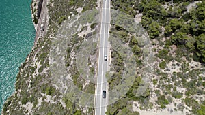 4K Aerial drone top down view of curves of Garraf coastal road over seashore