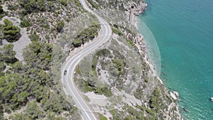 4K Aerial drone top down view of curves of Garraf coastal road over seashore