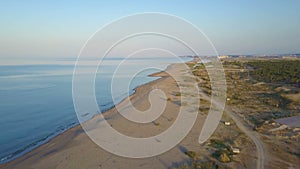 4K aerial drone view coastline, beach, surf break point, landscape with ocean background of sand dunes.