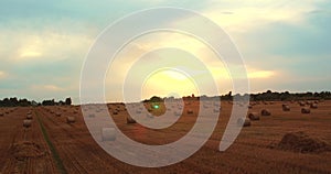 4k Aerial Field with Straw Bales Under Sunset Sky UltraHD drone