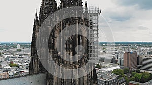 4k Aerial footage circling the historical Cologne Cathedral during it\'s renovation construction in Cologne, Germany.
