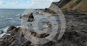 4k aerial footage of sea, rocks and cliffs at Elie Chain Walk