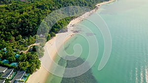 4K Aerial Front View of Surin Beach, Phuket. Beach, sea, sand and palms. Drone view of a beautiful white tropical sand beach on a