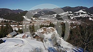 4k aerial top view of Yaremche Bukovel mountain house snowy forest. Big hills covered white snow