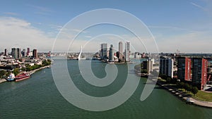 4k aerial video of the Rotterdam skyline seen from the Maas river, with the Erasmusbridge