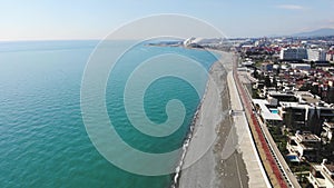 4k Aerial view of Adler, Sochi Beach, Town and Mountains. Waterfront Stretches Across the Coastline in this Russia