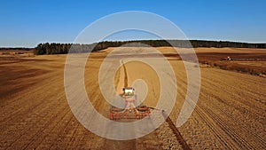 4K. Aerial view of agriculture process: tractors are plows and makes seeding, sowing agricultural crops at field