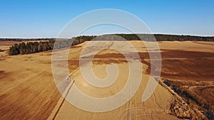 4K. Aerial view of agriculture process: tractors are plows and makes seeding, sowing agricultural crops at field