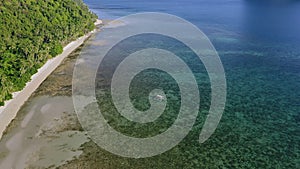 4k Aerial view of El Nido, Palawan, Philippines. Banca boat swimming in shallow water towards lonely tropical beach