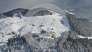 4K Aerial view of Fundata village from Rucar-Bran Pass in Romania during a winter morning at the bottom