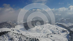 4K Aerial view of Fundata village from Rucar-Bran Pass in Romania during a winter morning at the bottom