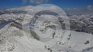 4K Aerial view of Fundata village from Rucar-Bran Pass in Romania during a winter morning at the bottom