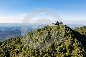 4K aerial view of a italian mountain church. Italian Alps, Trivero, Piemonte, Italy.