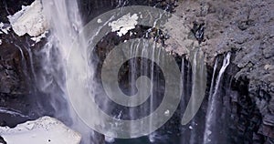 4K Aerial view of Kegon waterfall with snowy basalt wall, Japan.