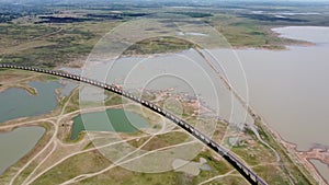 4K on Aerial view of railroad tracks for travel train parked with floating railway bridge