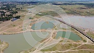 4K on Aerial view of railroad tracks for travel train parked with floating railway bridge