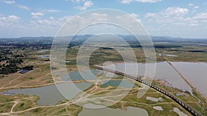 4K on Aerial view of railroad tracks for travel train parked with floating railway bridge