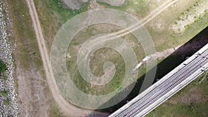 4K on Aerial view of railroad tracks for travel train parked with floating railway bridge