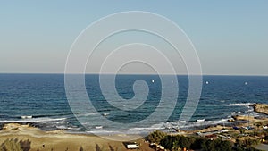 4k Aerial view of the sea with sailing boats in the distance.