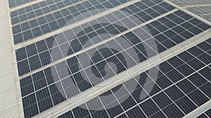 4K Aerial view of solar panels installed on roof of warehouse