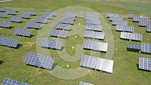4K Aerial view of solar power station. Drone flight over solar panels field. Renewable green alternative energy.