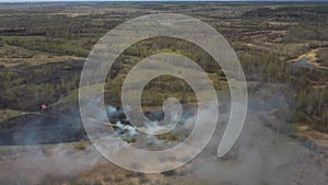 4K Aerial View Spring Dry Grass Burns During Drought Hot Weather. Bush Fire And Smoke. Firefighting Operation. Wild Open