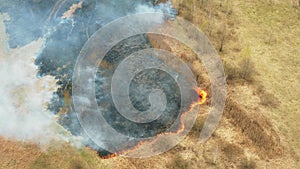 4K Aerial View Spring Dry Grass Burns During Drought Hot Weather. Bush Fire And Smoke. Firefighting Operation. Wild Open