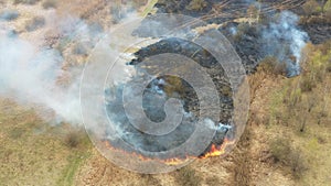 4K Aerial View Spring Dry Grass Burns During Drought Hot Weather. Bush Fire And Smoke. Firefighting Operation. Wild Open