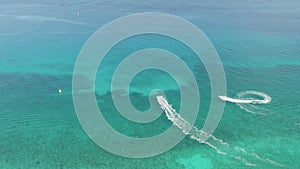 4k Aerial View Tracing Two Jet Skis Racing through Aqua Blue Caribbean Water