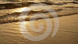 4K amazing sunset over the tropical beach. ocean beach waves on beach at sunset time , sunlight reflect on water surface.