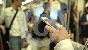 4K Asian Woman Stand up in the train using Smartphone in Subway of Taiwan