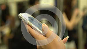 4K Asian Woman Stand up in the train using Smartphone in Subway of Taiwan