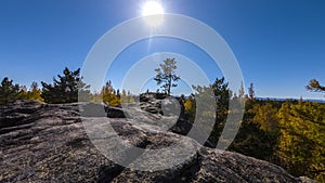 4K autumn time motion timelapse. sunset movement from the cliff above the forest