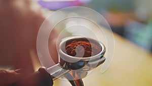 4k, barista tempering ground coffee into espresso pitcher, slow motion