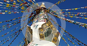 4k buddhist white stupa & flying prayer flags in shangrila yunnan,china.