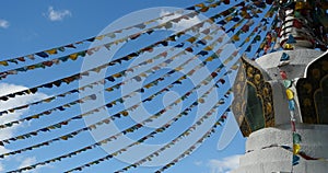 4k buddhist white stupa & flying prayer flags in shangrila yunnan,china.