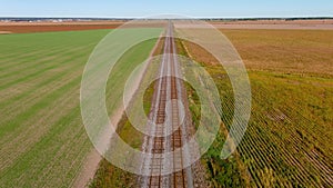 4K camera drone flying over rail road tracks in rural area