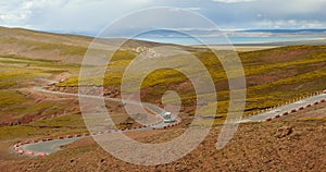 4k car driving on the meander road,distance lake namtso & mountain in tibet.