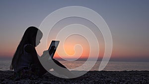 4K Child Playing Tablet on Beach, Sunset View Girl Silhouette Using Smart Phones