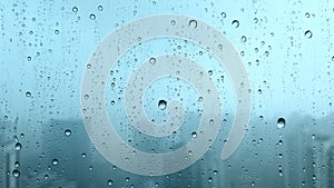 4K: Close up of rain drops on an office window
