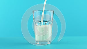 4K close-up shot of milk cold beverage drink pooring into faceted glass on colored blue background in studio