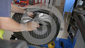 4K Close up shot tyre fitter is disassembling tyre from a wheel on a special tool